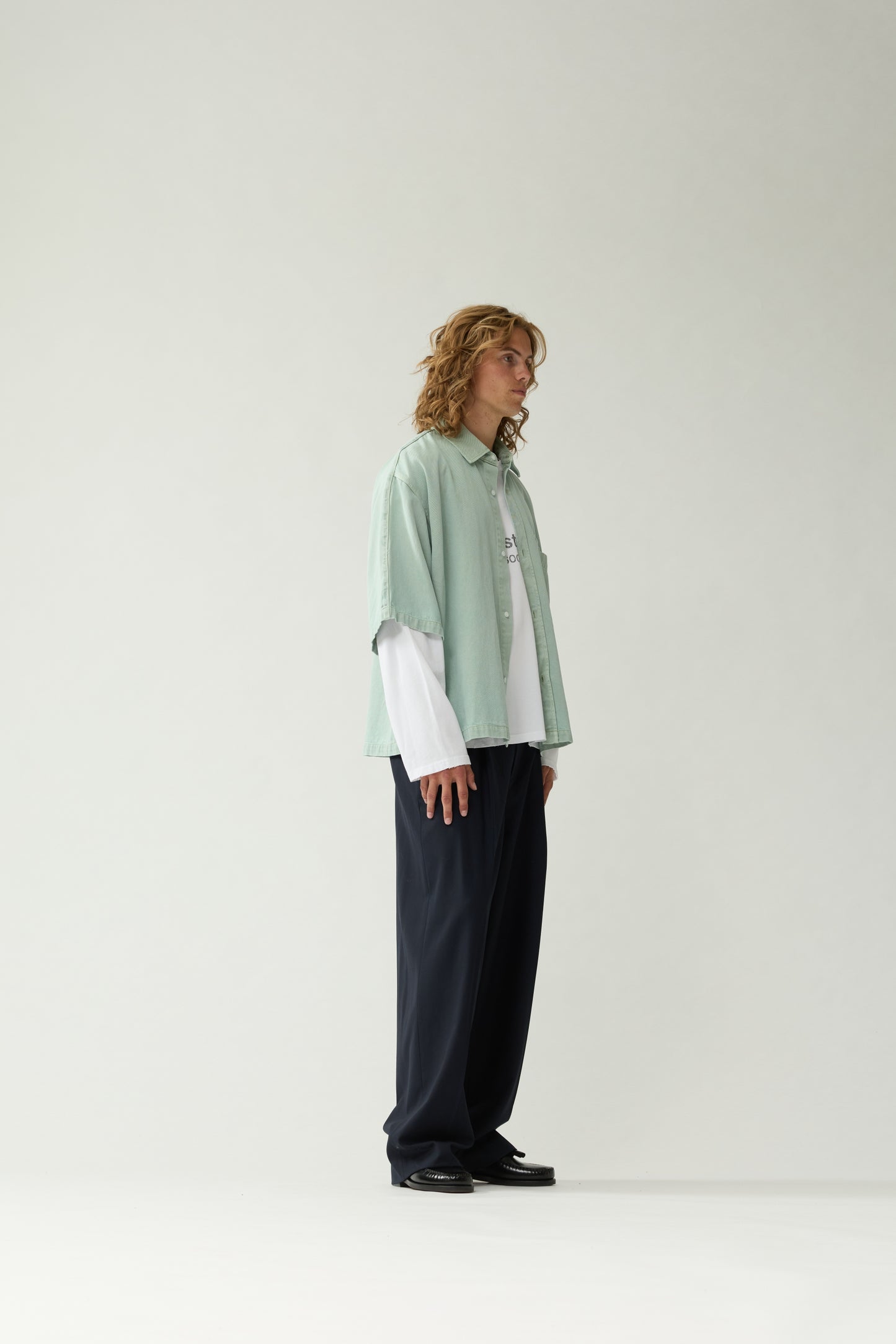 New Amsterdam Surf Association Mint Denim Short Sleeve Button-Up Shirt - Model Side Profile View Oversized Fit