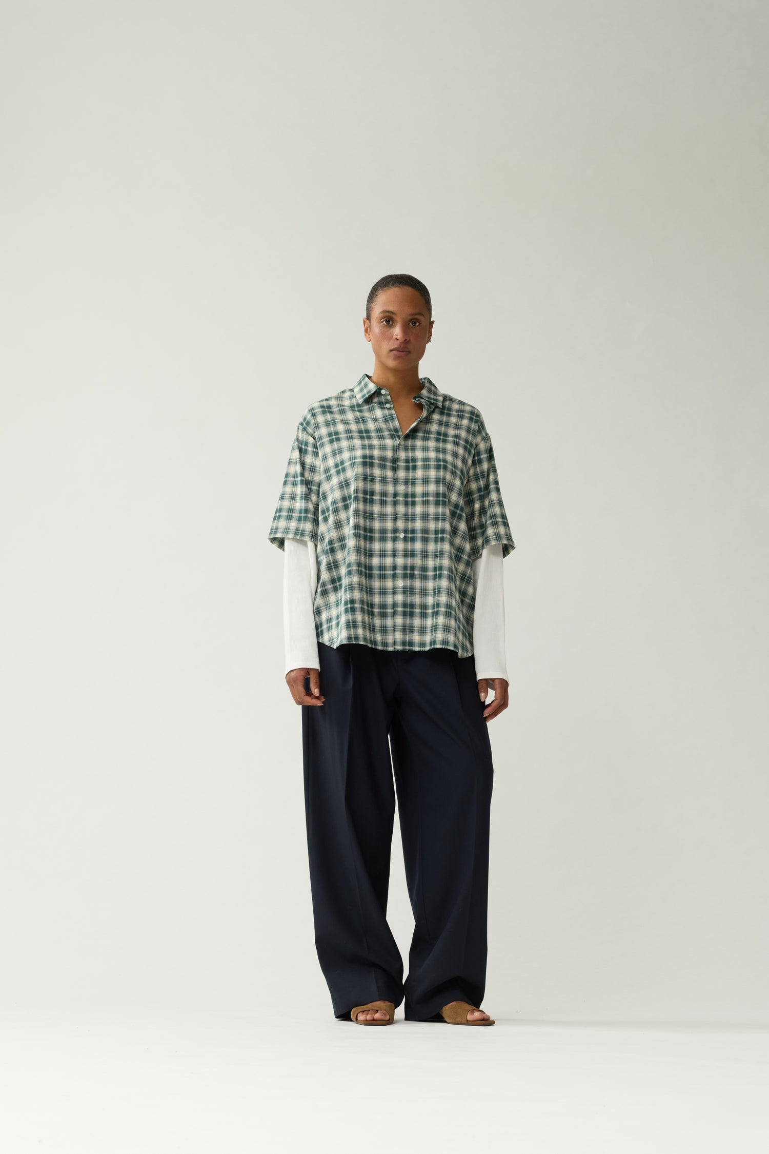 New Amsterdam Surf Association Double Layer Shirt in Green — female model wearing green/white check double layer shirt, front view, relaxed unisex fit with contrast white long sleeves