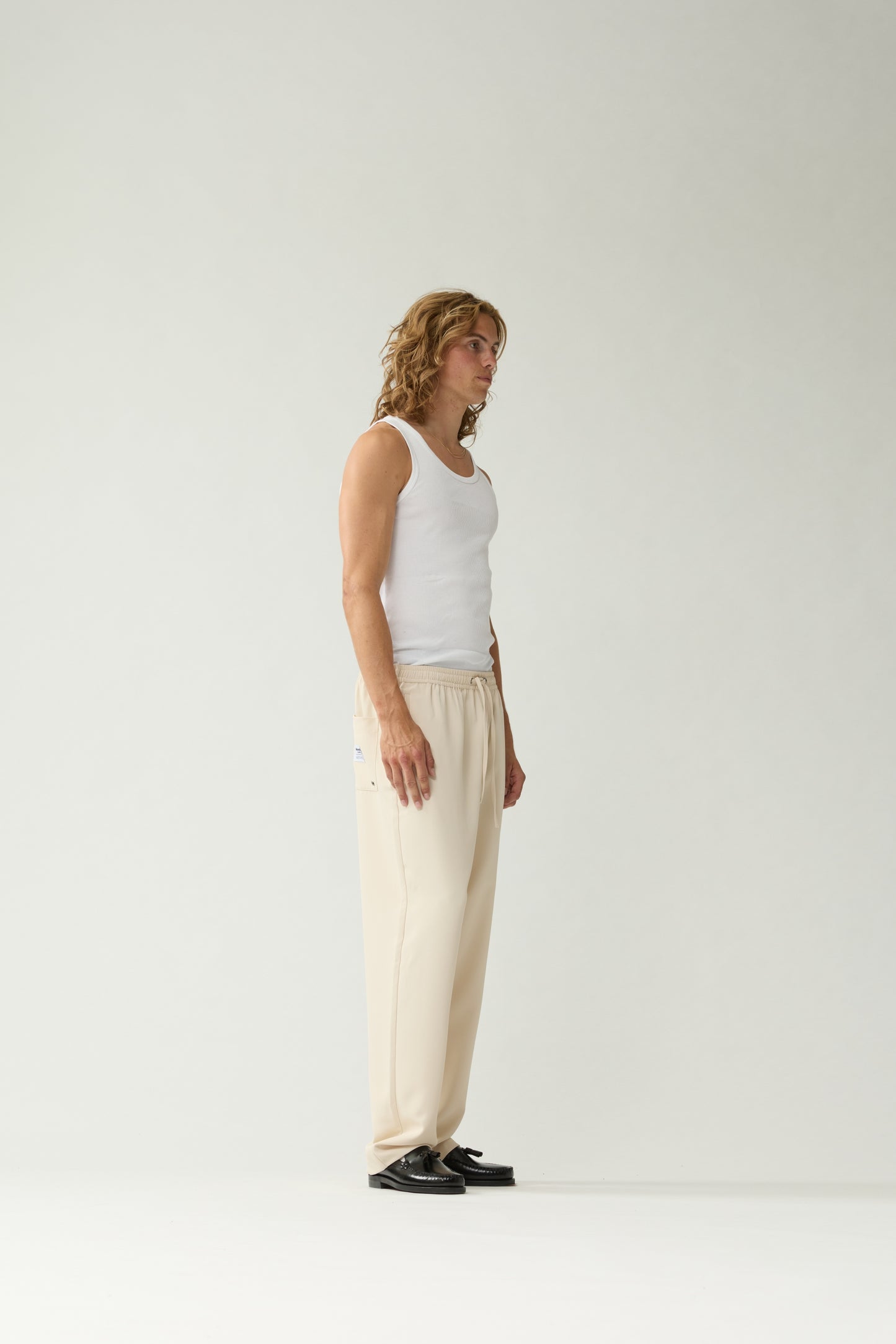 New Amsterdam Surf Association Sand Work Trousers - Model Side Profile View Straight Leg Drawstring Trousers
