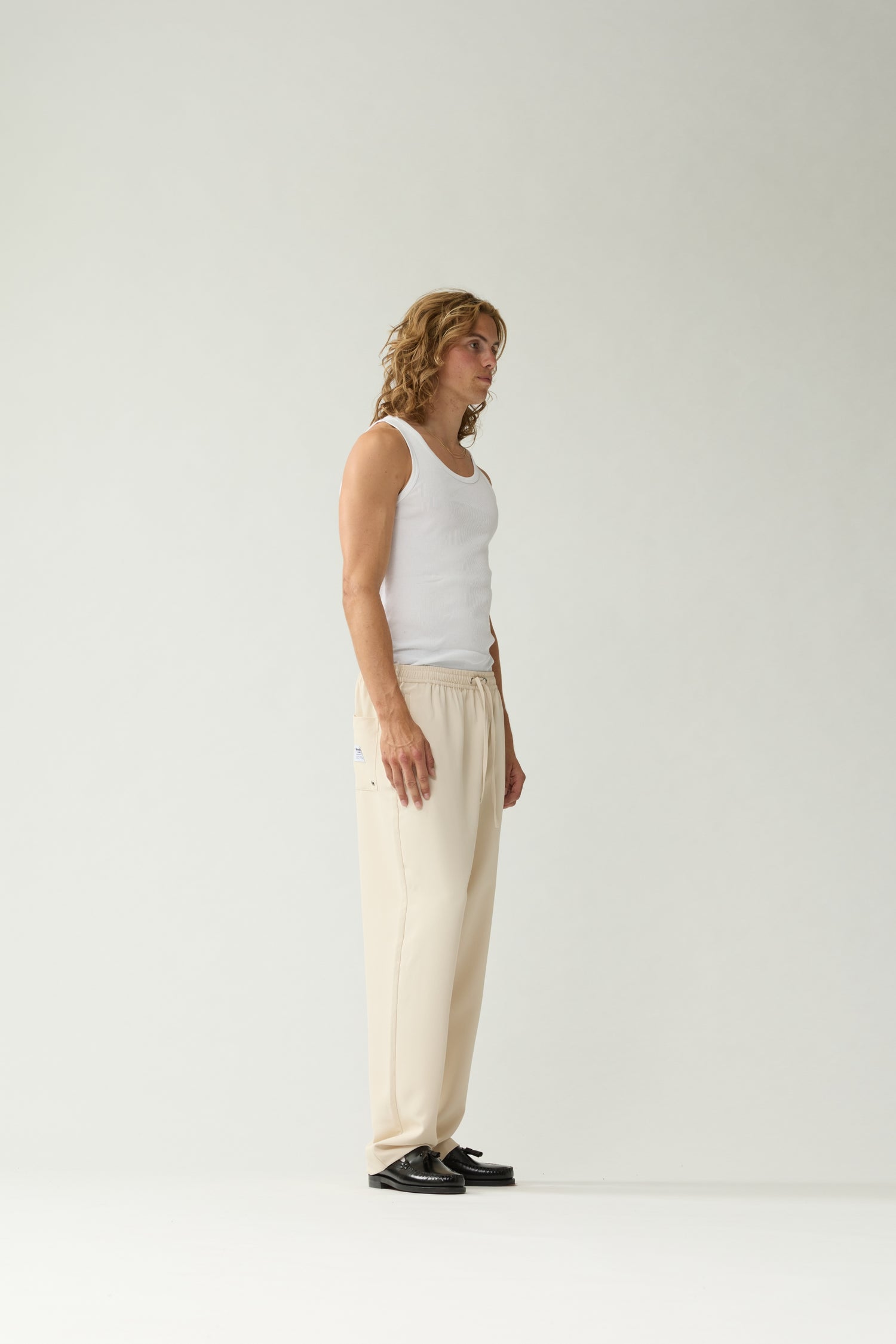 New Amsterdam Surf Association Sand Work Trousers - Model Side Profile View Straight Leg Drawstring Trousers