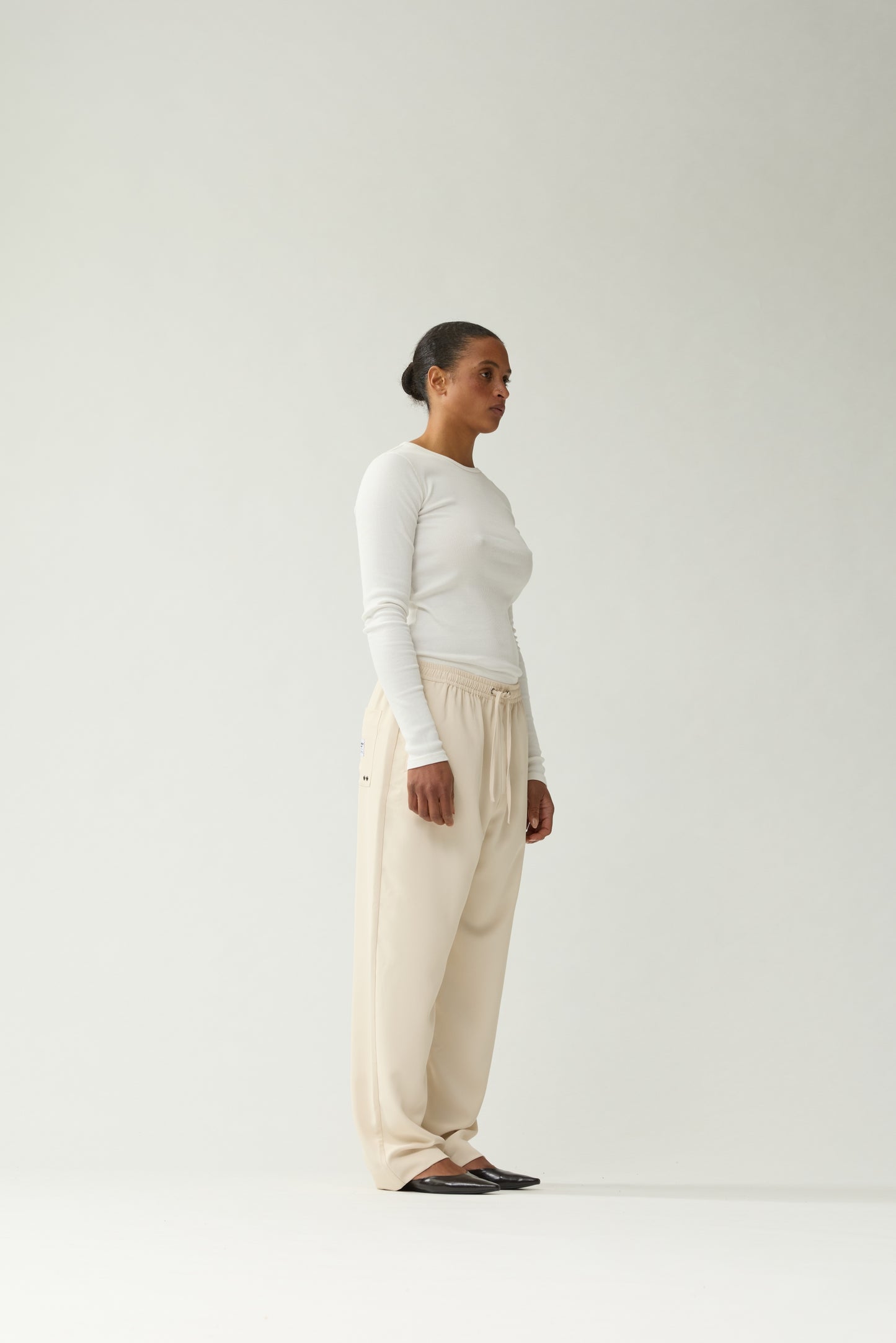 New Amsterdam Surf Association Sand Work Trousers - Model Side Profile View Relaxed Tapered Fit Casual Trousers