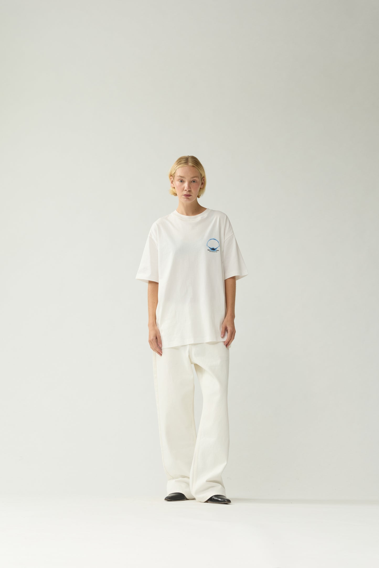New Amsterdam Surf Association White Eclipse Tee - Model Front View Unisex Oversized Short Sleeve Graphic Tee