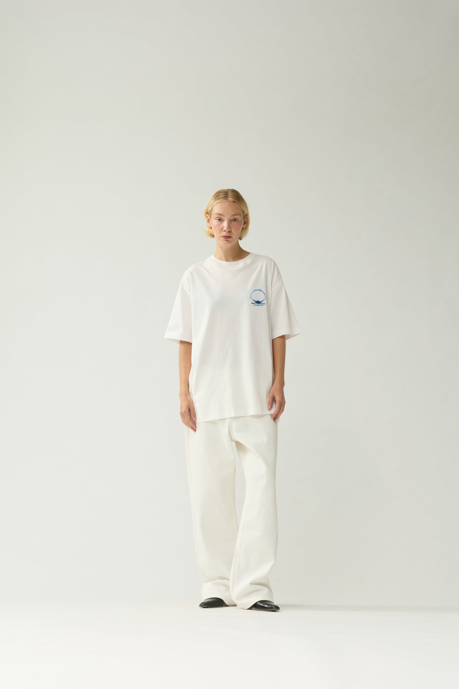 New Amsterdam Surf Association White Eclipse Tee - Model Front View Unisex Oversized Short Sleeve Graphic Tee