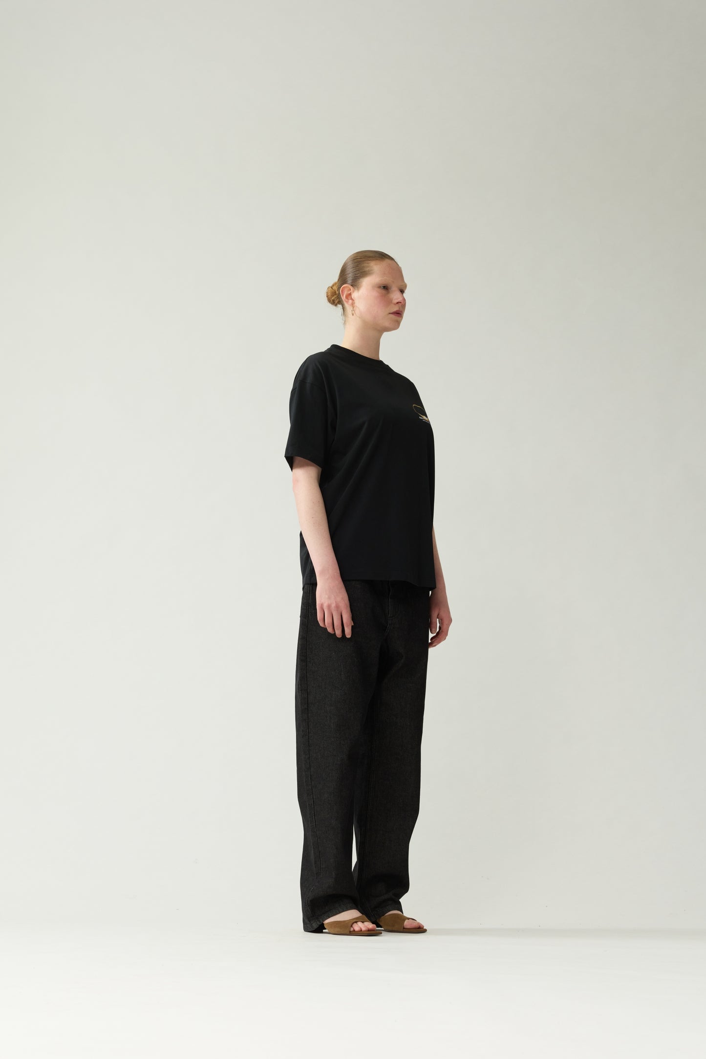 New Amsterdam Surf Association Black Eclipse Tee - Model Side Profile View Oversized Short Sleeve Cotton Tee Streetwear