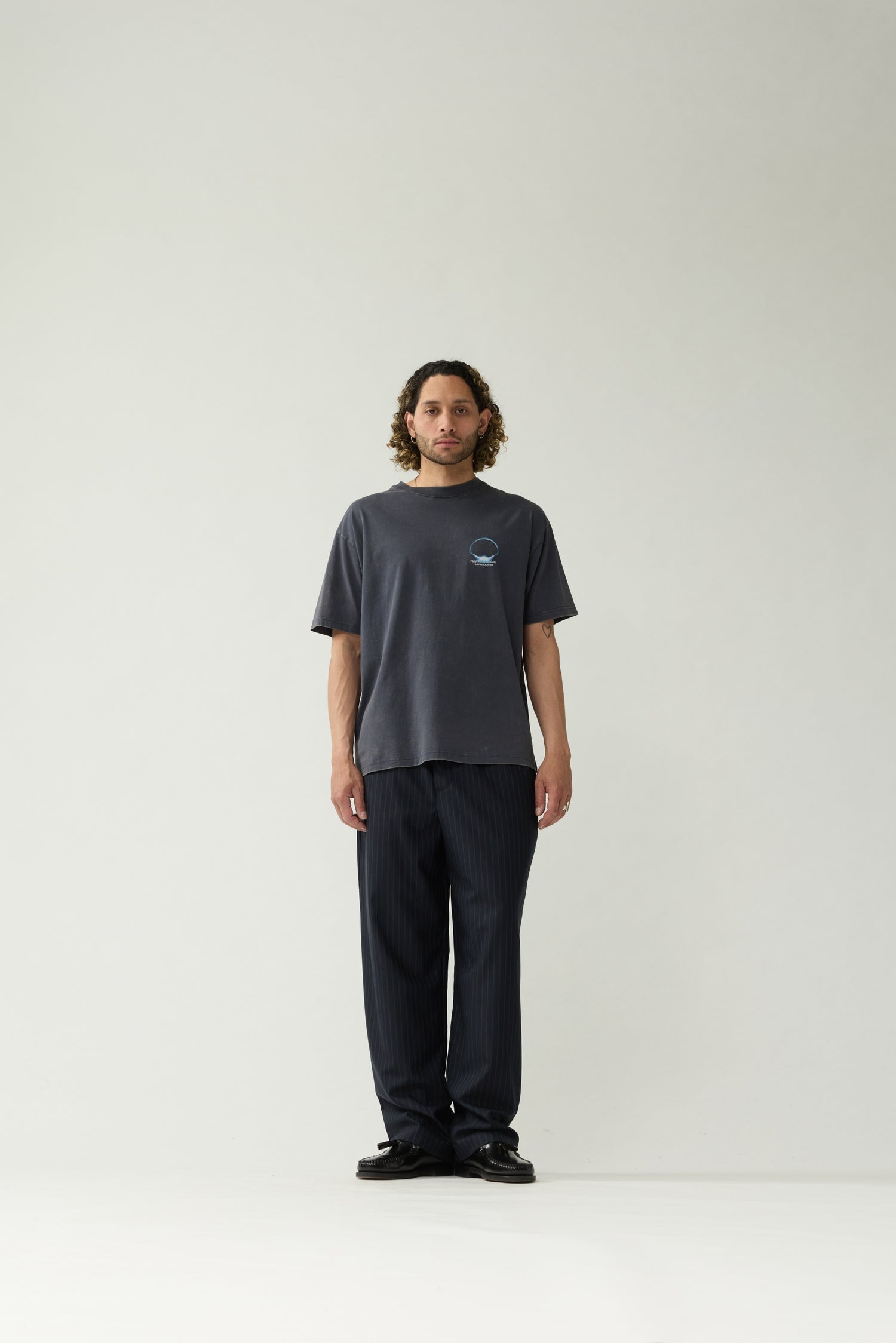 New Amsterdam Surf Association Eclipse Tee in Night — model wearing dark navy unisex crewneck tee, front view, regular fit