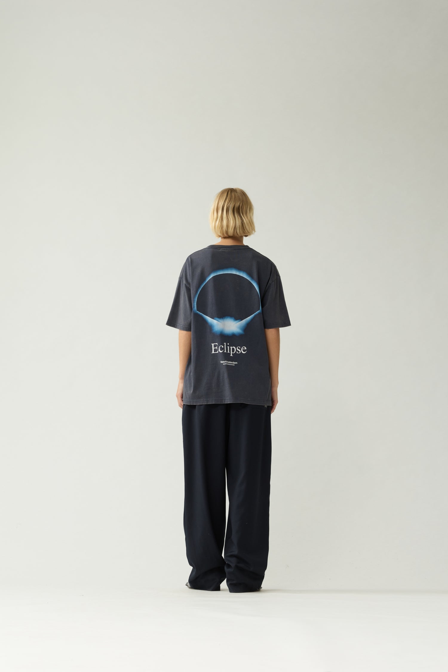 New Amsterdam Surf Association Eclipse Tee in Night — Women model wearing dark navy unisex crewneck tee, [front/back/side] detail view