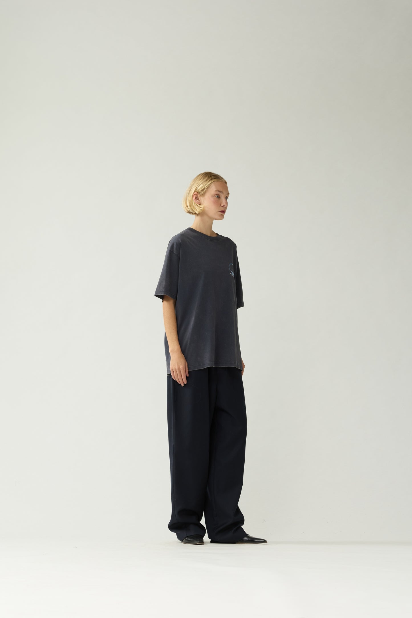 New Amsterdam Surf Association Eclipse Tee in Night — Women model wearing dark navy unisex crewneck tee, [front/back/side] detail view